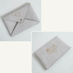 Vegan leather envelope in white – front with closure and back, both engraved